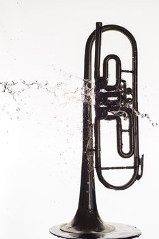 Old rusty wind pipe and water splashes isolated on white background.