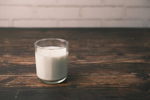 glass of milk on table with copy space .