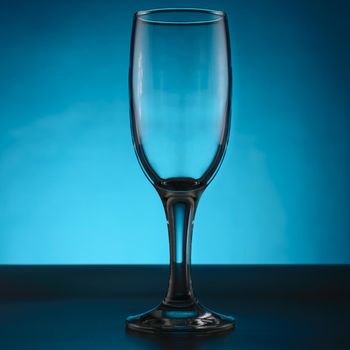 Empty champagne glass isolated on blue