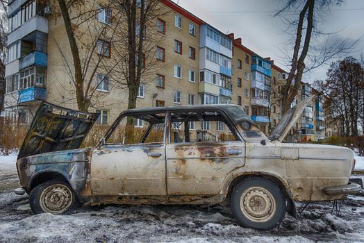 burnt out car near an apartment building