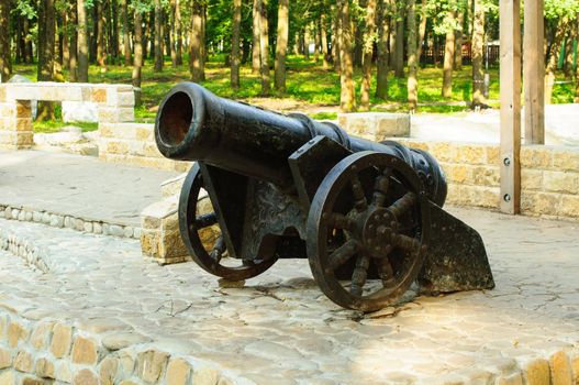 Ancient pig-iron gun on the bank of gulf. Mooring