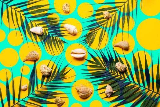 Flat lay traveler accessories with palm leaf, seashells . Top view travel or vacation concept. Summer background.