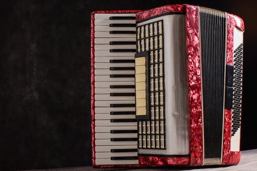 Mother of pearl accordion on a black background.