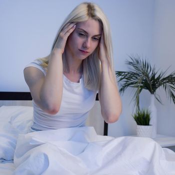 Depressed woman awake in the night, she is exhausted and suffering from insomnia - Image