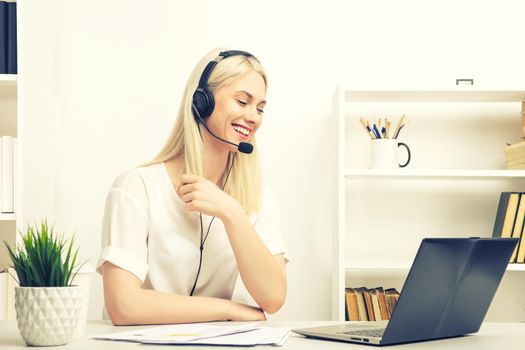 Close-up portrait of a customer service agent sitting at office -image toned