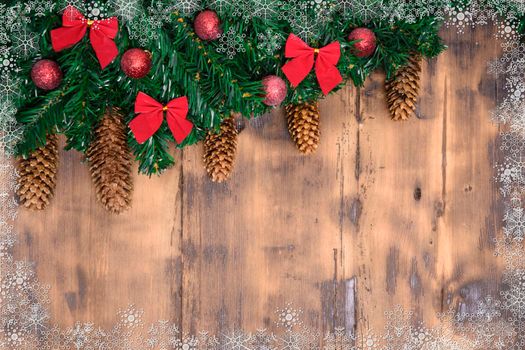 Decorated wooden background with Christmas tree branches.