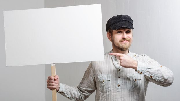 Angry protesting worker with blank protest sign.