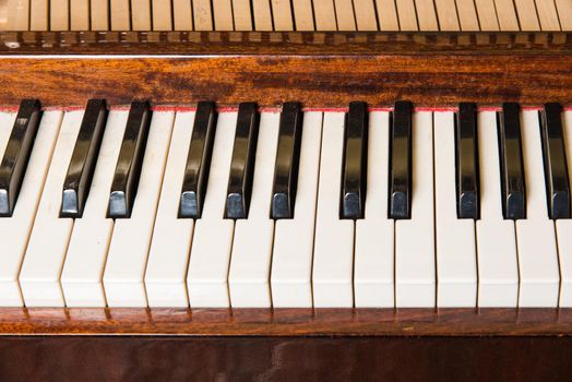 Piano keyboard background with selective focus. Warm color toned image