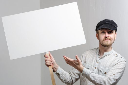 Angry protesting worker with blank protest sign.