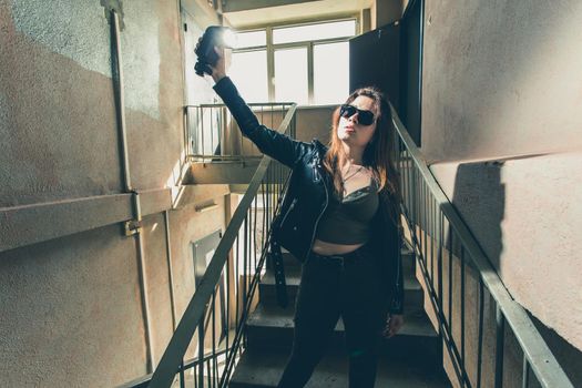 Women independence and feminism concept - Girl on dark stairs in military style