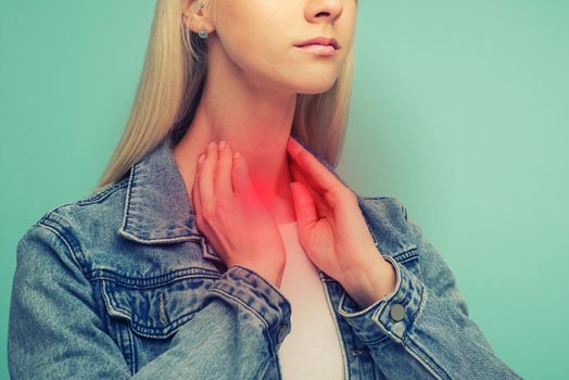 A young girl has a sore throat. Thyroid problems - Image toned