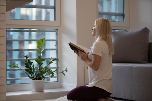 woman praying on holy bible in the morning. woman hand with Bible praying, concept for faith, spirituality and religion. Social distancing.