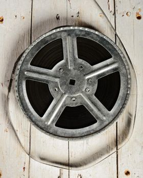 Movie reel on a white wooden background