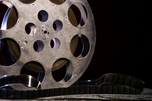 35 mm film reel with dramatic lighting on a dark background - image