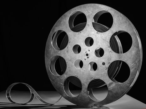 Reel of film on a black-white background.