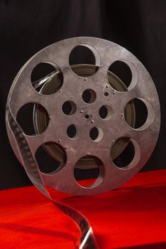 Movie reel on a red table and black background