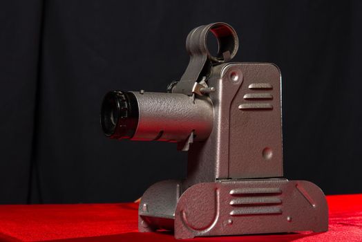 vintage movie spotlight on red table and black background