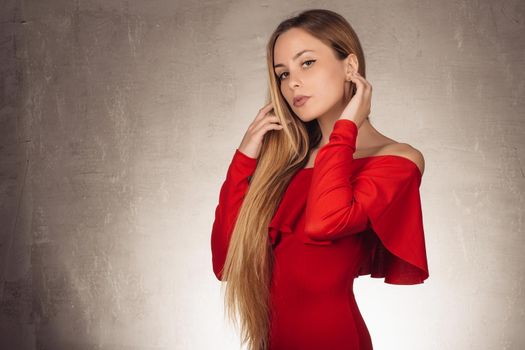 valentine's day portrait of an attractive young blonde girl in red dress