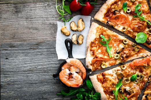 delicious pizza with seafood on wooden table