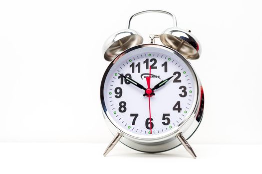 Metal retro alarm clock on white background - image