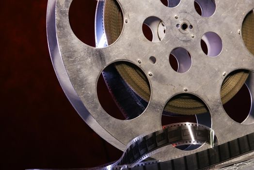 35 mm film reel with dramatic lighting on a dark background - image