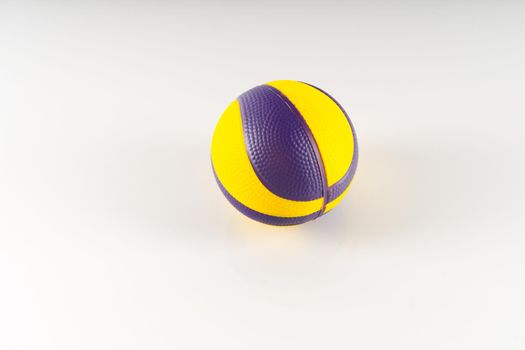 Basketball ball with yellow and purple spots on a white background. Antistress ball