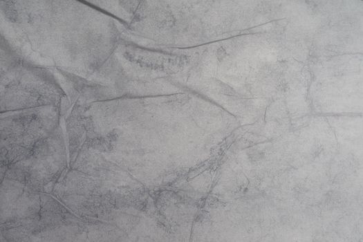 Texture of wet white folded paper on an outdoor poster wall, crumpled paper background. - image