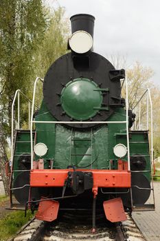 The Soviet steam locomotive on rails in a museum.