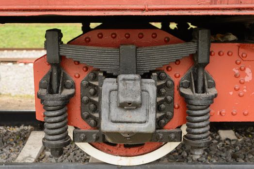 Wheel of old train car standing on the rails.