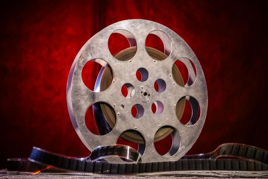 35 mm film reel with dramatic lighting on a dark background - image