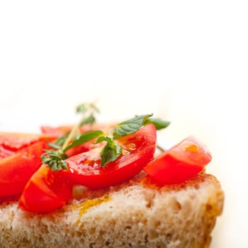 Italian tomato bruschetta with thyme and mint leaves 