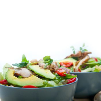 fresh and healthy Chicken Avocado salad over rustic wood table