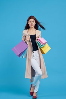 glamorous woman with multicolored bags posing isolated background. High quality photo