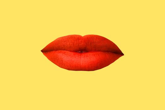 Woman's lips close up isolated on yellow background.
