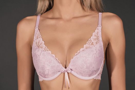 close up of sexy female breast in lilac lace bra