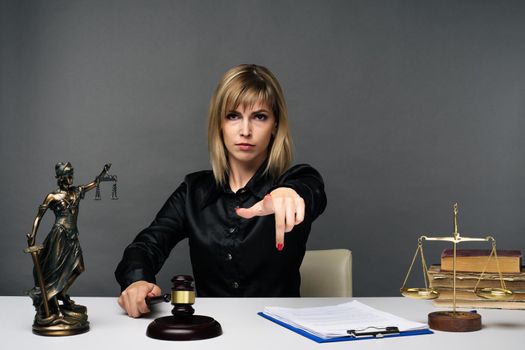 A young fair woman judge works in her office. - image