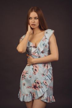 Beautiful young puffy lips woman in floral dress posing in studio. - image