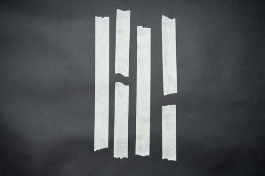 Set of white scotch tapes on black background. Torn vertical and different size white sticky tape, adhesive pieces.