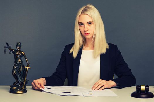 Female lawyer working at table in office - image toned