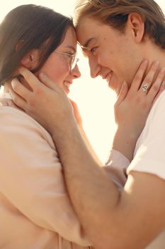 Couple in a summer park. Man in a white t-shirt.