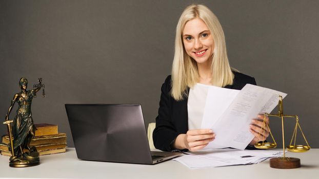 Portrait of smiling businesswoman looking at camera and smiling while working at office - image