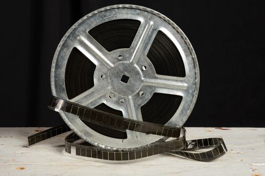 Movie reel on a white wooden background