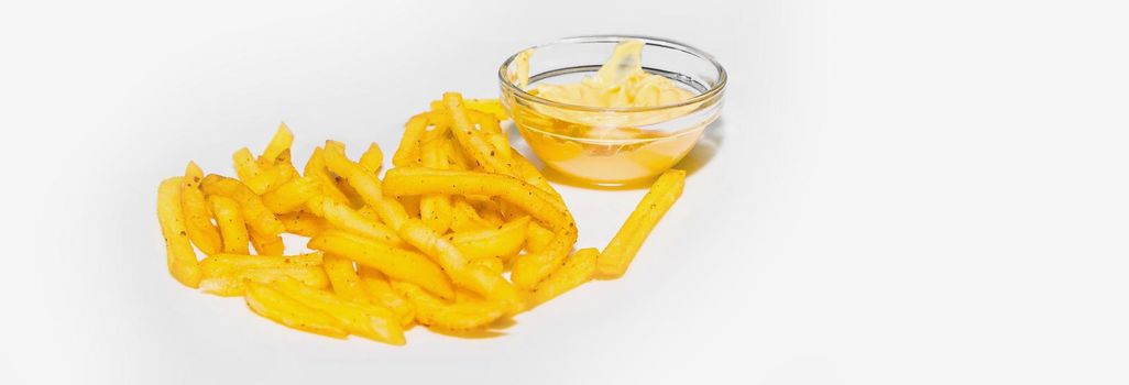 French fries with spices next to cheese sauce isolated on white background.