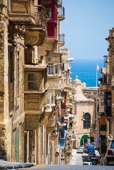 traditional Valletta street with balconies down to the sea in Malta