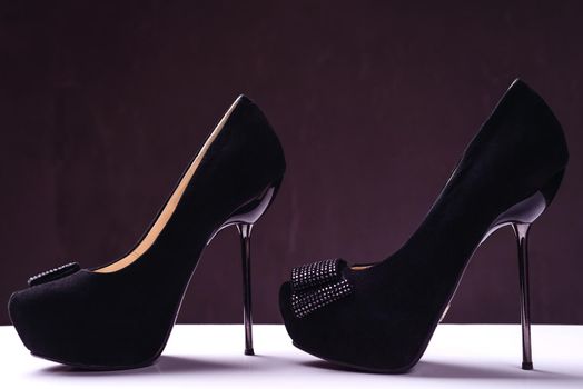 Pair of elegant high heel shoes on background. Black footwear.