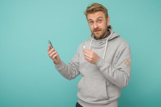 Tula, Russia - May 1, 2019: Happy Man listening music Apple AirPods wireless - Image