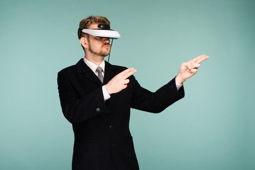 Businessman in a formal wear wearing virtual reality glasses pointing fingers away - image