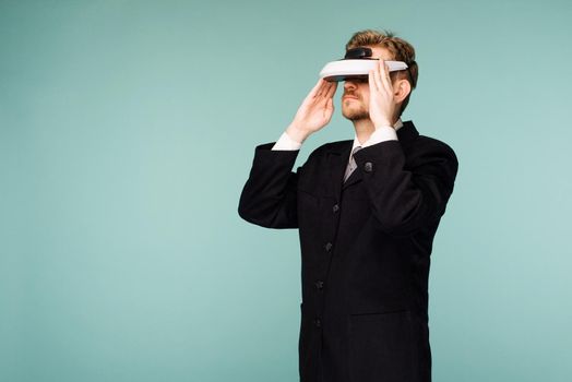 Businessman in a formal wear wearing virtual reality glasses - image