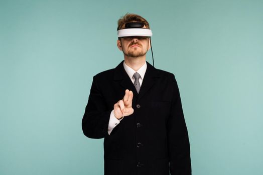 Businessman in a formal wear wearing virtual reality glasses - image