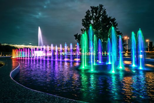 colorful illuminated musical fountain in Warsaw at dusk